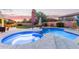 Backyard featuring a sparkling pool and spa with water feature, surrounded by lush landscaping at 1684 E Coconino Dr, Chandler, AZ 85249