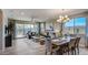 Open concept dining area with a rustic wood table at 19417 W Badgett Ln, Litchfield Park, AZ 85340