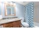 Bathroom vanity with granite countertop, wood cabinets, and stylish shower curtain at 200 E Southern Ave # 118, Tempe, AZ 85282