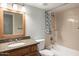 Well-lit bathroom with granite countertop and bathtub at 200 E Southern Ave # 118, Tempe, AZ 85282