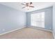 Bright bedroom with a ceiling fan and light fixture, and carpet flooring at 200 E Southern Ave # 118, Tempe, AZ 85282