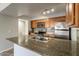 Granite countertop kitchen island with a double sink at 200 E Southern Ave # 118, Tempe, AZ 85282