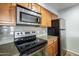 Stainless steel appliances and wood cabinets in this kitchen at 200 E Southern Ave # 118, Tempe, AZ 85282