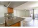 Kitchen with granite countertops and views into living room at 200 E Southern Ave # 118, Tempe, AZ 85282