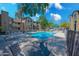 Community pool with patio table and lounge chairs at 200 E Southern Ave # 118, Tempe, AZ 85282