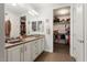 Bathroom with double vanity, large mirror, and walk-in closet at 20515 N 274Th Ln, Buckeye, AZ 85396