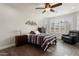 Bedroom with a striped comforter, ceiling fan, and wood flooring at 20515 N 274Th Ln, Buckeye, AZ 85396