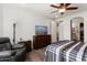 Main bedroom with a dresser, TV, and ceiling fan at 20515 N 274Th Ln, Buckeye, AZ 85396