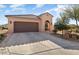 House exterior showcasing a garage and desert landscaping at 20515 N 274Th Ln, Buckeye, AZ 85396