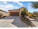 Front view of a tan house with a brown garage door and walkway at 20515 N 274Th Ln, Buckeye, AZ 85396