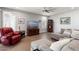 Living room featuring a sectional sofa, a red armchair, and a TV at 20515 N 274Th Ln, Buckeye, AZ 85396