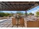 Built-in outdoor kitchen with grill under a pergola at 20515 N 274Th Ln, Buckeye, AZ 85396