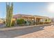 Landscaped backyard with a covered patio and desert plants at 2144 S Yellow Wood Ave, Mesa, AZ 85209