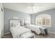 Guest bedroom with twin beds, window seating, and a ceiling fan at 2144 S Yellow Wood Ave, Mesa, AZ 85209