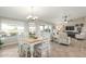 Open concept dining area with adjacent living room and large windows at 2144 S Yellow Wood Ave, Mesa, AZ 85209