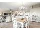 Bright dining room features a wood table with white chairs, offering a space for Gathering meals at 2144 S Yellow Wood Ave, Mesa, AZ 85209