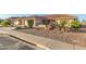 Landscaped front yard of a single-story house with a tan exterior at 2144 S Yellow Wood Ave, Mesa, AZ 85209