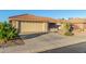 House exterior showcasing a tan stucco finish, tile roof, and desert landscaping at 2144 S Yellow Wood Ave, Mesa, AZ 85209