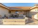 Covered patio with seating area, featuring a tile floor and desert landscaping at 2144 S Yellow Wood Ave, Mesa, AZ 85209