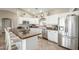 Modern kitchen with white cabinets, stainless steel appliances, and an island at 2144 S Yellow Wood Ave, Mesa, AZ 85209