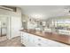 Kitchen island with white cabinets and a view into living room and dining area at 2144 S Yellow Wood Ave, Mesa, AZ 85209