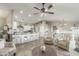 Open living room and kitchen with beige furniture, wood flooring, and ceiling fan at 2144 S Yellow Wood Ave, Mesa, AZ 85209