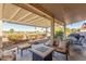 Relaxing covered patio with fire pit and comfortable seating at 2144 S Yellow Wood Ave, Mesa, AZ 85209