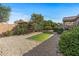 Landscaped backyard with gravel, artificial turf, and patio at 22205 N Cochise Ln, Sun City West, AZ 85375