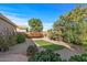 Landscaped backyard with gravel, artificial turf, and patio at 22205 N Cochise Ln, Sun City West, AZ 85375