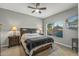 Comfortable bedroom with ceiling fan, large window, and TV at 22205 N Cochise Ln, Sun City West, AZ 85375