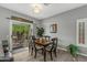 Cozy dining area with a wooden table and chairs, near sliding doors at 22205 N Cochise Ln, Sun City West, AZ 85375