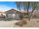 Single-story home with a two-car garage and desert landscaping at 22205 N Cochise Ln, Sun City West, AZ 85375