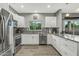 Modern kitchen with white cabinets, granite counters, and stainless steel appliances at 22205 N Cochise Ln, Sun City West, AZ 85375