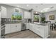 Spacious kitchen featuring granite countertops and white cabinetry at 22205 N Cochise Ln, Sun City West, AZ 85375