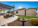 Landscaped backyard with a pergola, seating area, and a birdbath at 22331 N 80Th Ave, Peoria, AZ 85383