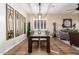 Elegant dining room with a wood table, sleek chairs, and large mirrors on the wall at 22331 N 80Th Ave, Peoria, AZ 85383