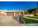 Three-car garage, attractive landscaping, and a welcoming front porch at 22331 N 80Th Ave, Peoria, AZ 85383