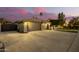 Spacious driveway, three-car garage, and elegant gated entryway at 22331 N 80Th Ave, Peoria, AZ 85383