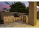 Built-in outdoor kitchen with grill and mini-fridge at 22331 N 80Th Ave, Peoria, AZ 85383