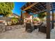 Relaxing patio area with fireplace and comfortable seating under a pergola at 22331 N 80Th Ave, Peoria, AZ 85383