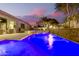 Night view of a refreshing pool with water features and a relaxing patio area at 22331 N 80Th Ave, Peoria, AZ 85383