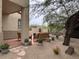 Landscaped backyard with patio, seating area, and mature trees at 23575 N 75Th Pl, Scottsdale, AZ 85255