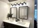 Elegant bathroom with double sinks, updated lighting, and modern mirrors at 23575 N 75Th Pl, Scottsdale, AZ 85255