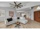 Open living room with a sectional sofa and view into the dining area at 23575 N 75Th Pl, Scottsdale, AZ 85255