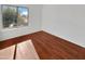 Well-lit bedroom featuring hardwood floors and a window at 2946 E Grove Cir, Mesa, AZ 85204