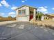 Two-story house with red door, attached garage, and landscaping at 2946 E Grove Cir, Mesa, AZ 85204