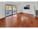 Bright living room with hardwood floors and sliding glass doors leading to a patio at 2946 E Grove Cir, Mesa, AZ 85204