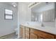 Bright bathroom with double sinks, wood cabinets, and a shower at 33868 N Mercedes Dr, San Tan Valley, AZ 85144