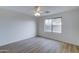 Bedroom with wood floors, ceiling fan and backyard view at 33868 N Mercedes Dr, San Tan Valley, AZ 85144