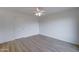 Simple bedroom with wood floors and ceiling fan at 33868 N Mercedes Dr, San Tan Valley, AZ 85144